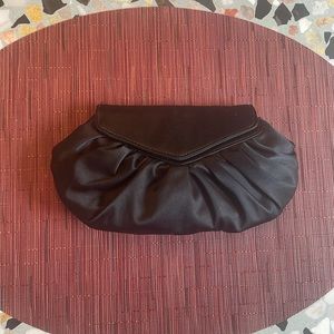 Dainty black satin clutch by Laura Merkin